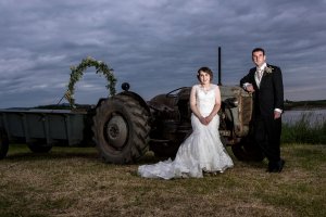 West midlands wedding photographer Matthew Clarke photographs newlyweds on a tractor in Worcester